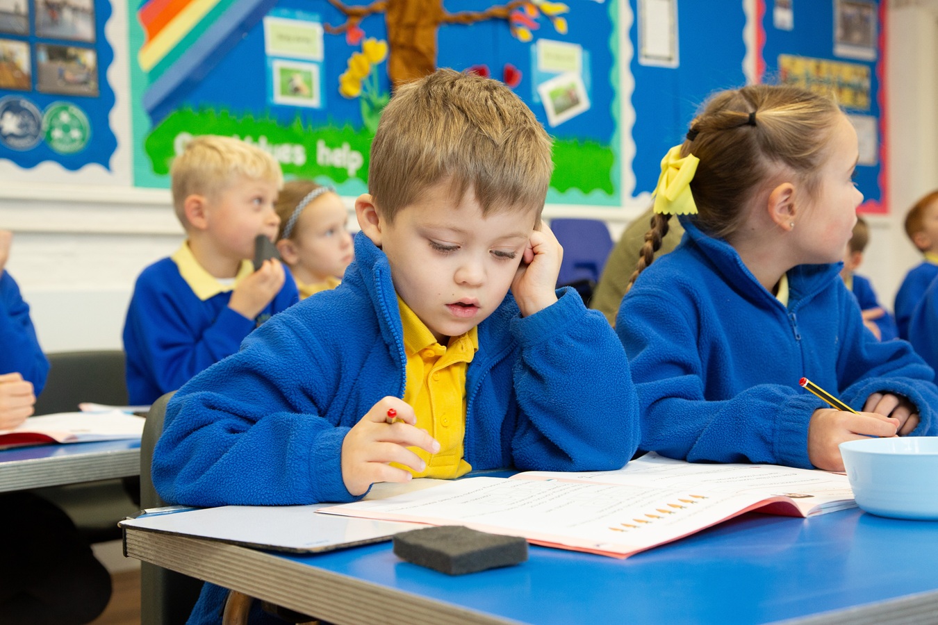 child at desk reading